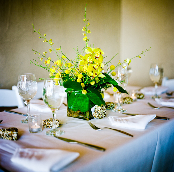 beautiful yellow and green floral centerpiece on reception table - photo by New Mexico based wedding photographers Twin Lens